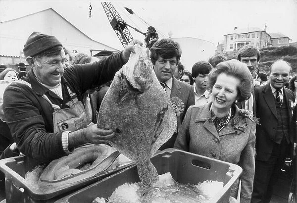 MARGARET THATCHER IS SHOWN A LARGE TURBOT BY LIFEBOAT MECHANIC EDDIE MURT IN PADSTOW