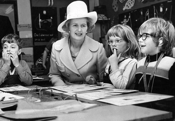 Margaret Thatcher sits with children taking a reading class at the Northern Councties