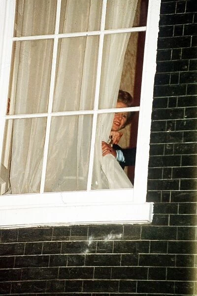 Margaret Thatcher watches through the window at No 10 Downing Street 1990