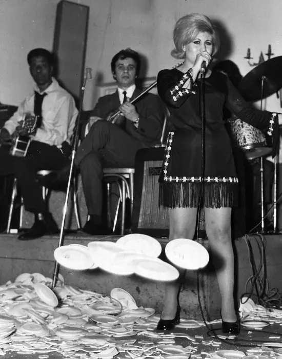 Framed Print : Maria Ikonomidou sings as plates break at her feet 1970 at Elysee Greek Restaurant