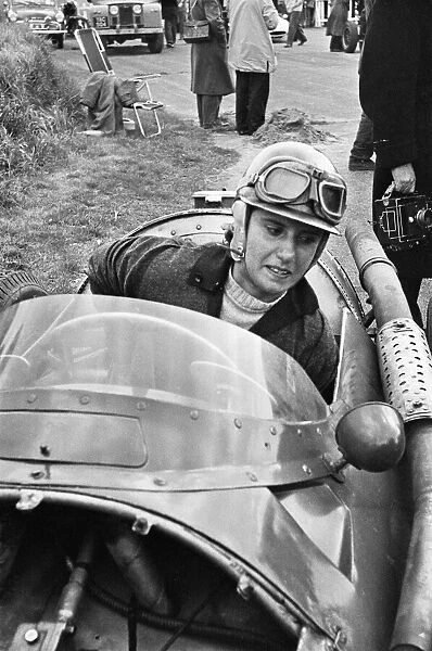 Maria Teresa de Filippis pictured in her Red Maserati 250F before for the BRDC