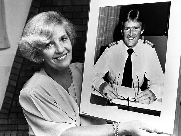 Marie Duffy with a photograph of her husband John who is Hotel Manager of the QE2 which