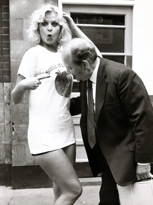 Framed Print : Marie Louis wearing a T Shirt with Strawberry Print as a man moves in to have a smell Framed Print : Marie Louis wearing a T Shirt with Strawberry Print as a man moves in to have a smell
