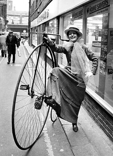 Marie Wood of Formons in victorian dress complete with her penny farthing bike
