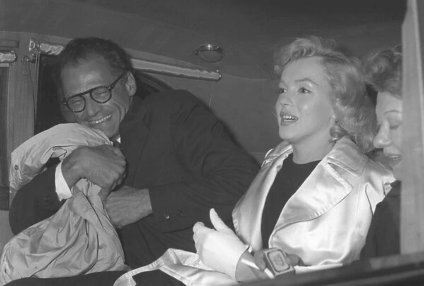 Marilyn Monroe and Arthur Miller in back of car
