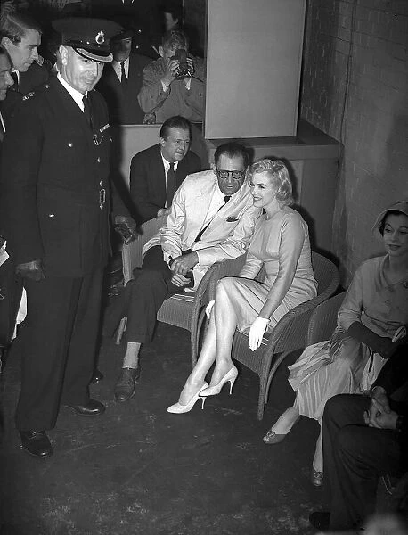 Marilyn Monroe with Arthur Miller at London airport and actress Vivien Leigh July