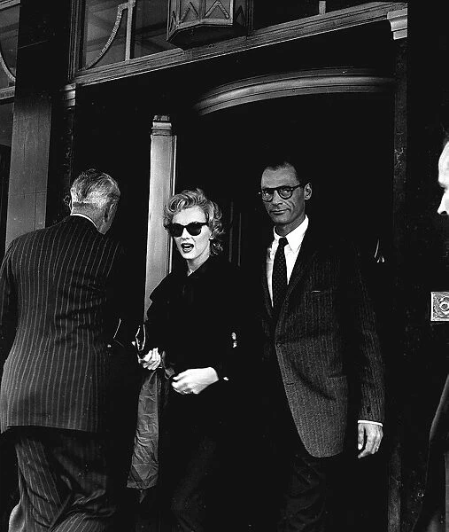 Marilyn Monroe and husband Arthur Miller leave their London hotel after an interview