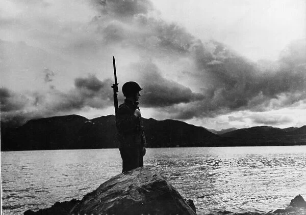 A US Marine looks out across the waters towards of the Aleutian Islands