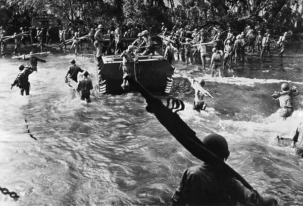 US Marines carrying stretchers splash through the surf after having disembarked from huge