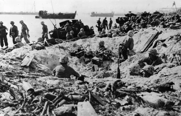 Framed Print : US marines take shelter in a shell hole on Namur Island in the Kwajalein Atoll