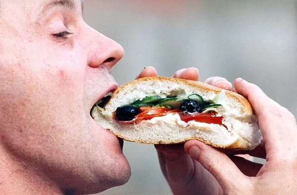 Mark Reeve of Denes Deli in Jesmond eating his winning sandwich in 1995