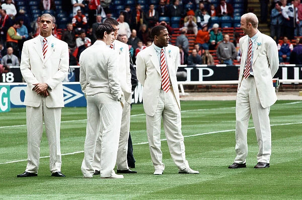 Mark Wright (right) and John Barnes with fellow Liverpool team mates on the pitch at