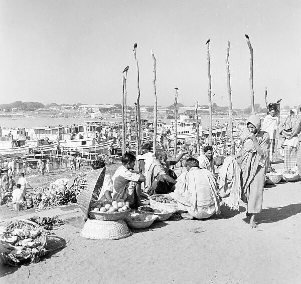 Market traders beside the harbour set up their stalls in Dacca, Bangladesh