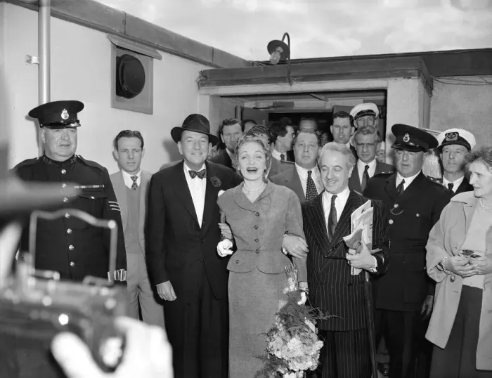 Framed Print : Marlene Dietrich arriving in London for Cabaret actress surrounded by men