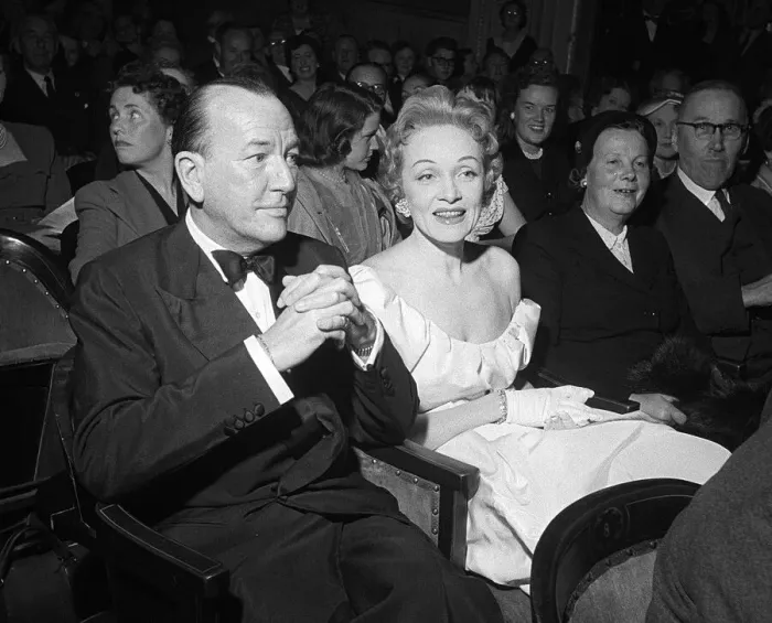 Framed Print : Marlene Dietrich sitting in the stalls of the Globe Theatre with Noel Coward whose play