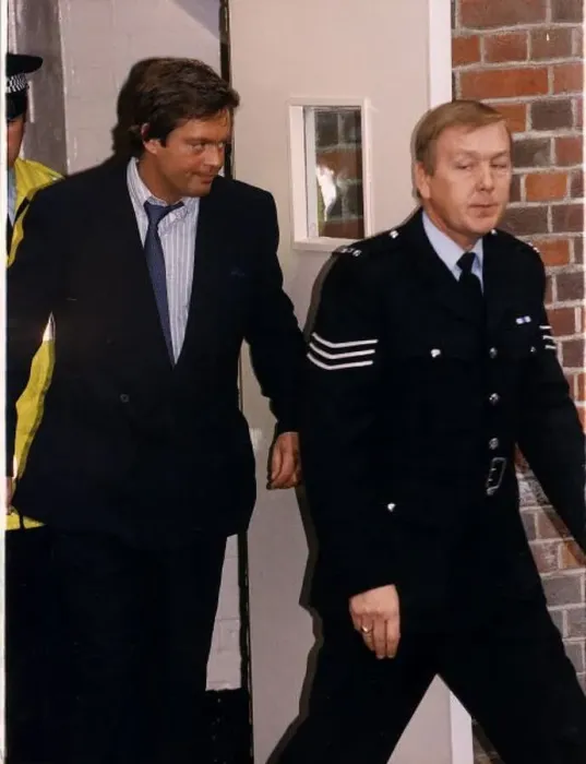  : Marquis of Blandford is led away by policemen from Beaconsfield Crown Court Dbase