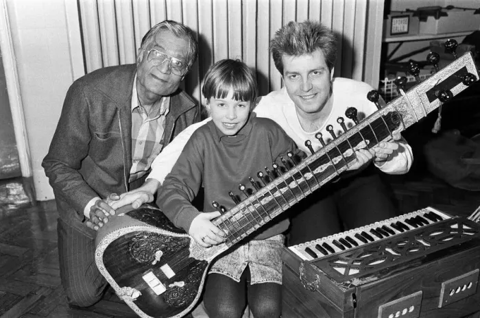 Framed Print : Martine Bochat (centre) gets a lesson on the sitar from Virendra Bhatt (left Framed Print : Martine Bochat (centre) gets a lesson on the sitar from Virendra Bhatt (left