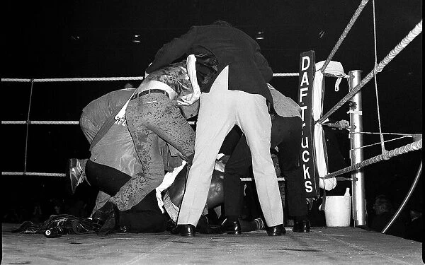 Marvin Hagler is shielded from bottles by referee 1980 after beating Alan Minter in