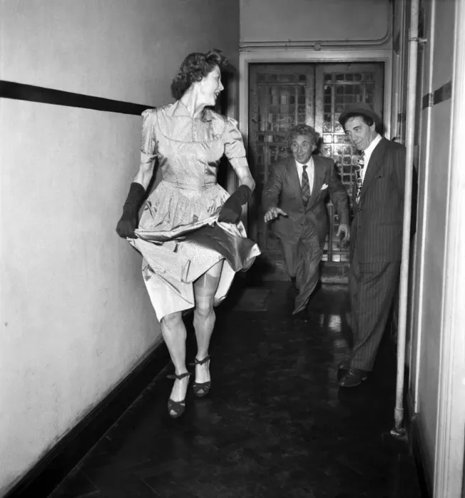 Framed Print : Marx Brothers. Harpo and Chico watching a woman walk by wearing a dress. May 1949 O18773 Framed Print : Marx Brothers. Harpo and Chico watching a woman walk by wearing a dress. May 1949 O18773