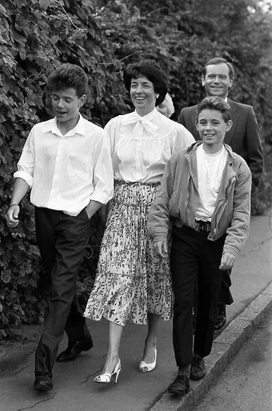 Mary and Jeffrey Archer walking home from church with their sons William and James