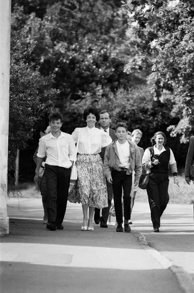 Mary and Jeffrey Archer walking home from church with their sons William and James