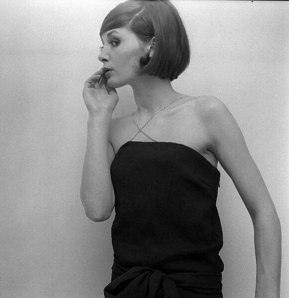 Mary Quant fashion clothing Model looking worried wearing a black dress with cross