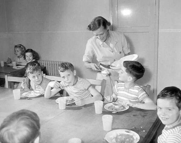 Matron Muriel Hale from Birmingham is serving up second helpings to children at