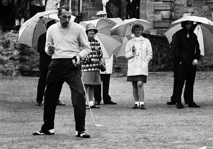 Framed Print : Max Faulkner contemplates his putt at the British Golf Open as spectators keep dry with Framed Print : Max Faulkner contemplates his putt at the British Golf Open as spectators keep dry with
