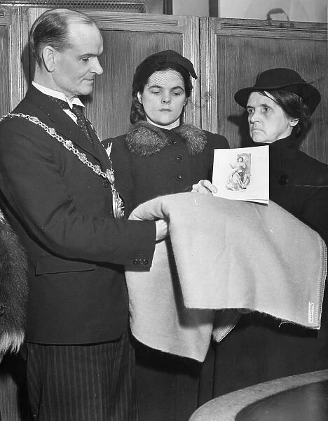 The Mayor of Bootle (Alderman Js Kelly) presenting the blanket which the Queen sent to