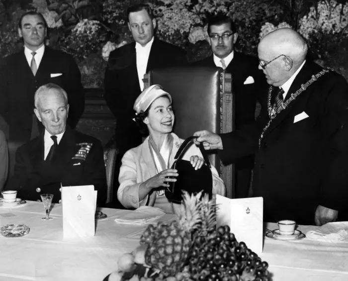 Framed Print : The Mayor of Dudley presents the Queen with a black leather handbag during her visit to Framed Print : The Mayor of Dudley presents the Queen with a black leather handbag during her visit to