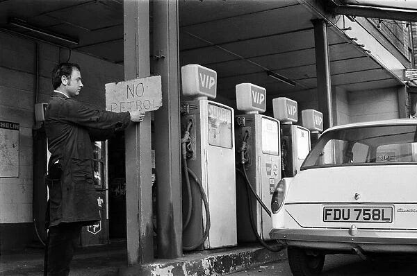 Mechanic Mr Keith Brodrick, putting up a 'No Petrol'