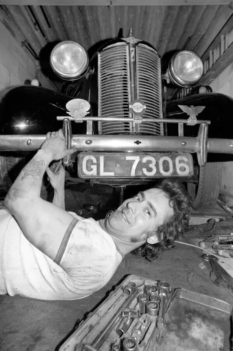 Framed Print : Mechanic underneath a car, making repairs April 1975 75-02158-010 Framed Print : Mechanic underneath a car, making repairs April 1975 75-02158-010