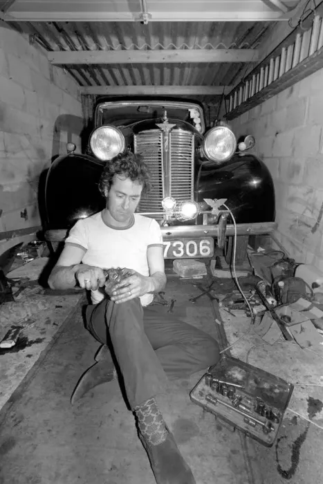 Framed Print : Mechanic underneath a car, making repairs April 1975 75-02158-013 Framed Print : Mechanic underneath a car, making repairs April 1975 75-02158-013