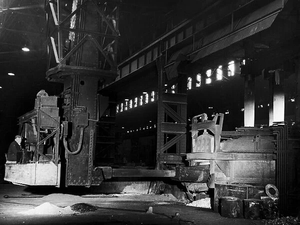 A mechanical charging machine feeding a 30 ton electric arc furnace at the English Steel