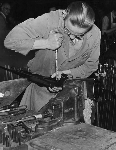 Mechanical Engineer works on a rifle in gun factory, Gun Quarter area of Birmingham, 1950