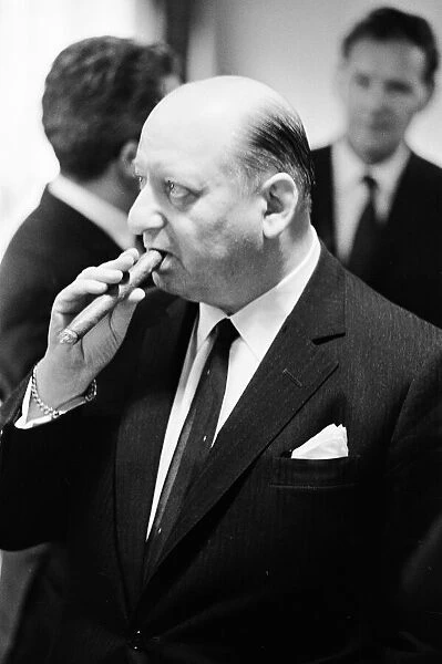 Media Mogul Lord Lew Grade poses for the camera smoking a cigar. 24th January 1967