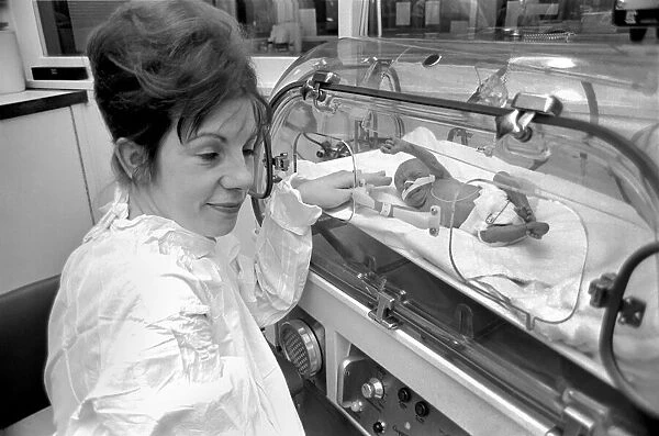 Medical. Mrs. Rosemary Letts holds baby Cara for the first time in the incubator at