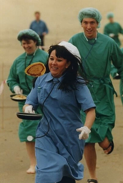 Medical staff take part in a Shrove Tuesday Pancake Race along the North East Coast line