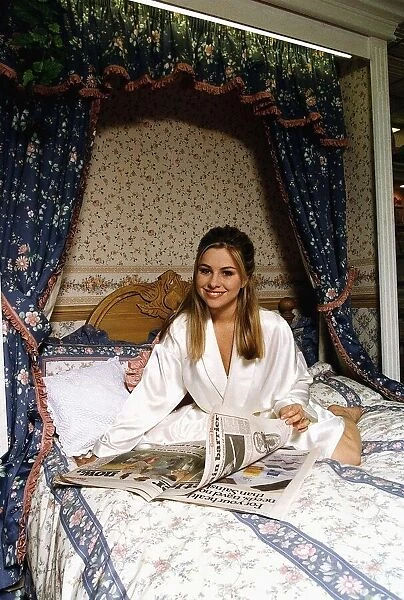 Melissa Bell Actress Laying On A Bed Reading The Newspaper