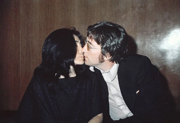 Former member of The Beatles pop group John Lennon with his wife Yoko Ono at Heathrow