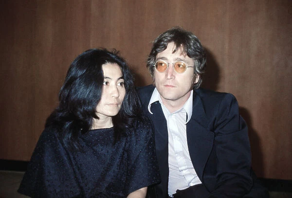 Former member of The Beatles pop group John Lennon with his wife Yoko Ono at Heathrow