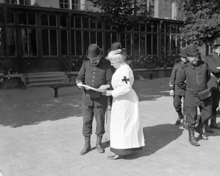 Framed Print : A member of the Belgian Civil Guard seen here in Brussels with Red Cross nurse Circa Framed Print : A member of the Belgian Civil Guard seen here in Brussels with Red Cross nurse Circa