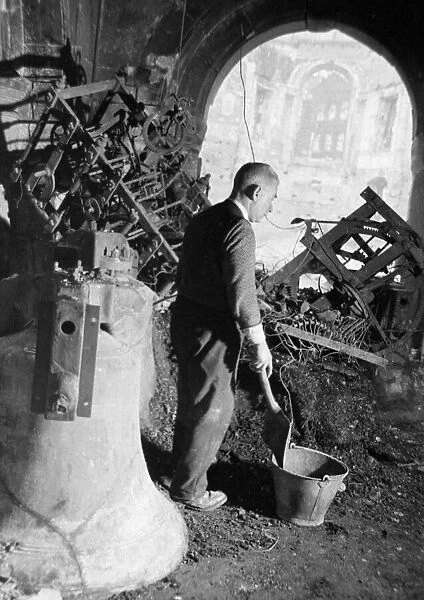 A member of the congregation digs through the remains of the belfry of St Clements Dane