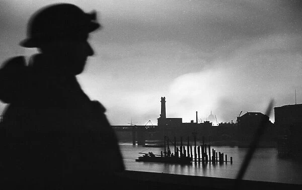 A member of the Home Guard looks north across the River Thames