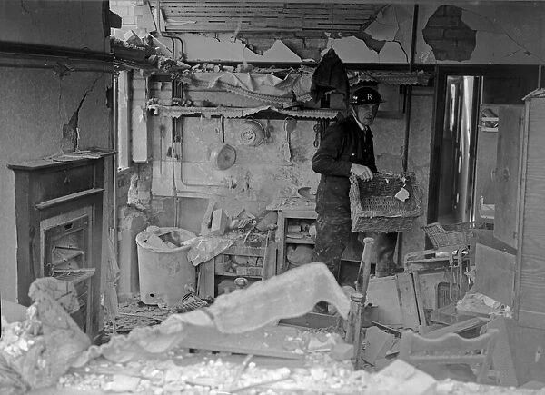 A member of the Rescue service help save belongings from a bombed house in Kings Heath