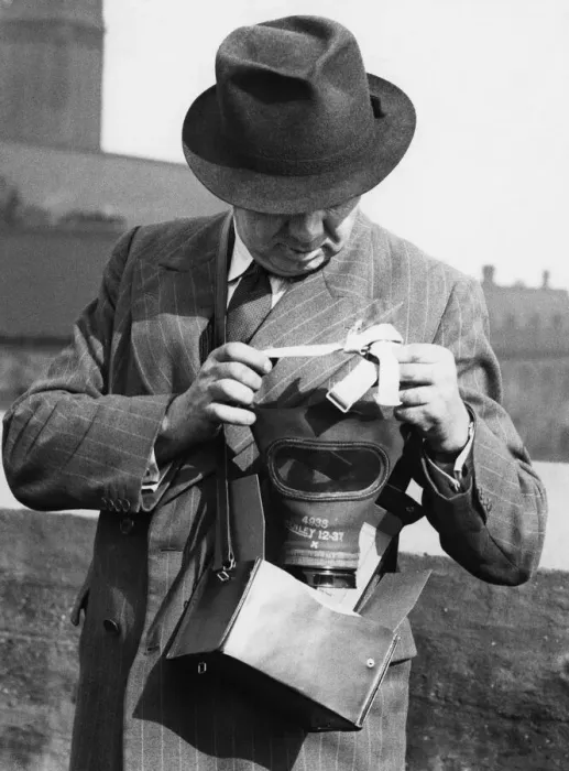 Framed Print : A member of the Sunday Mercury staff demonstrating how to put a gas mask Framed Print : A member of the Sunday Mercury staff demonstrating how to put a gas mask