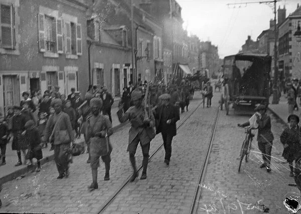 Members of the 3rd Lahore Indian Division marching through the streets of Orleans, France