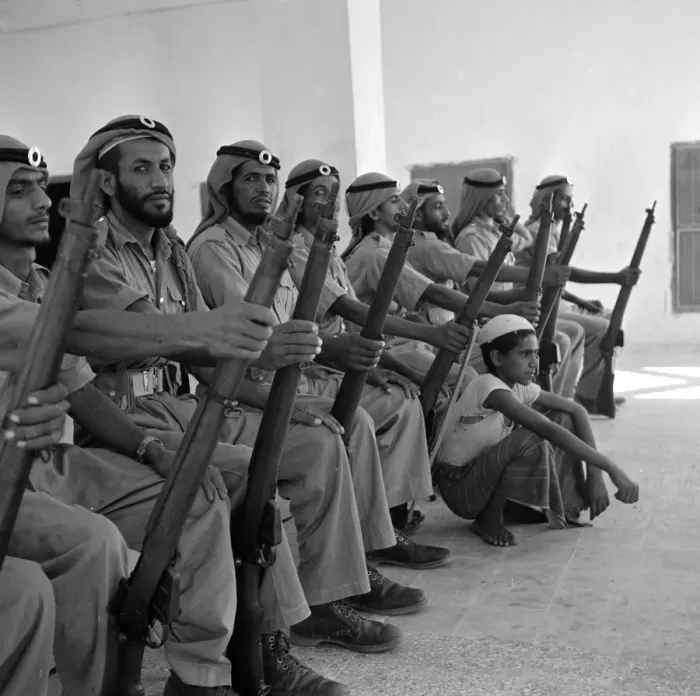 Framed Print : Members of the Abu Dhabi defence force pose for the camera with a young boy in Framed Print : Members of the Abu Dhabi defence force pose for the camera with a young boy in