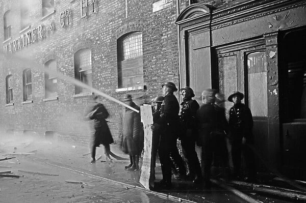 Members of the Auxiliary Fire Service and London Fire Brigade seen here fighting a fire