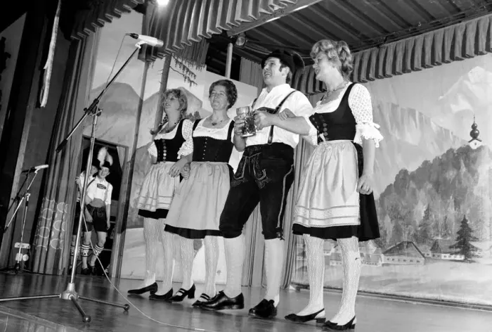 Framed Print : Members of a Bavarian band performing on stage wearing traditional Bavarian dress during